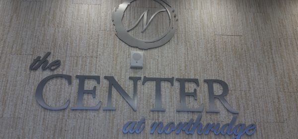 New ¼” brushed aluminum logo and name installed onto tile wall